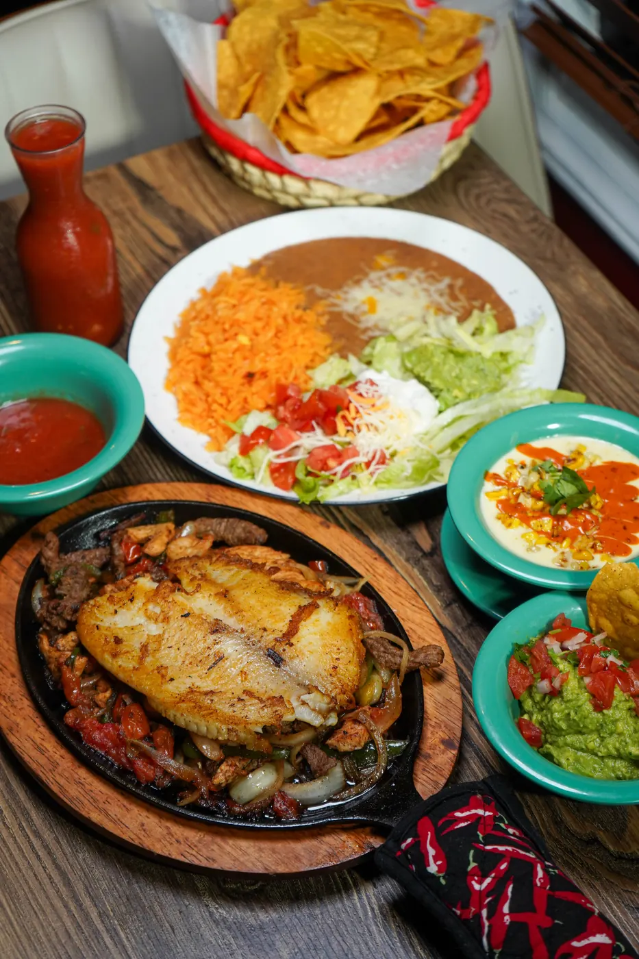 Fajitas, rice, beans and guacamole on the table